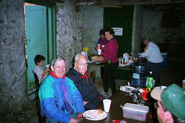 Brian Yates, Ken Newcomb and others at lunch in the Stone Barn after the fall 1998 cleanup